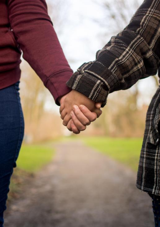 Mother and daughter holding hands